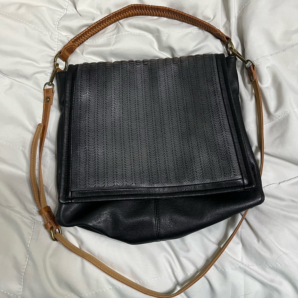 Free people cross body bag. Black with tan straps. Excellent condition.